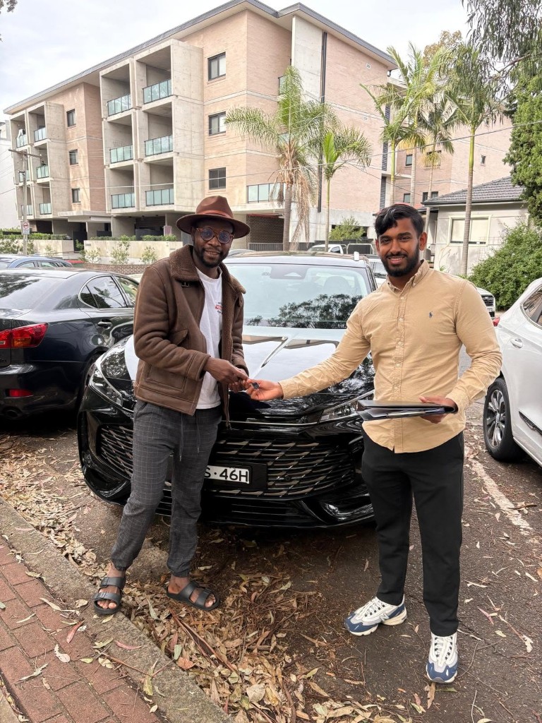 A customer collecting their car at a Car Rentals Near Me handover