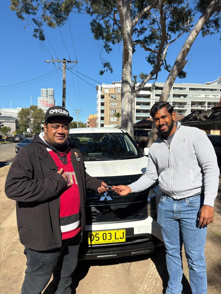 A customer collecting their car at a Car Rentals Near Me handover