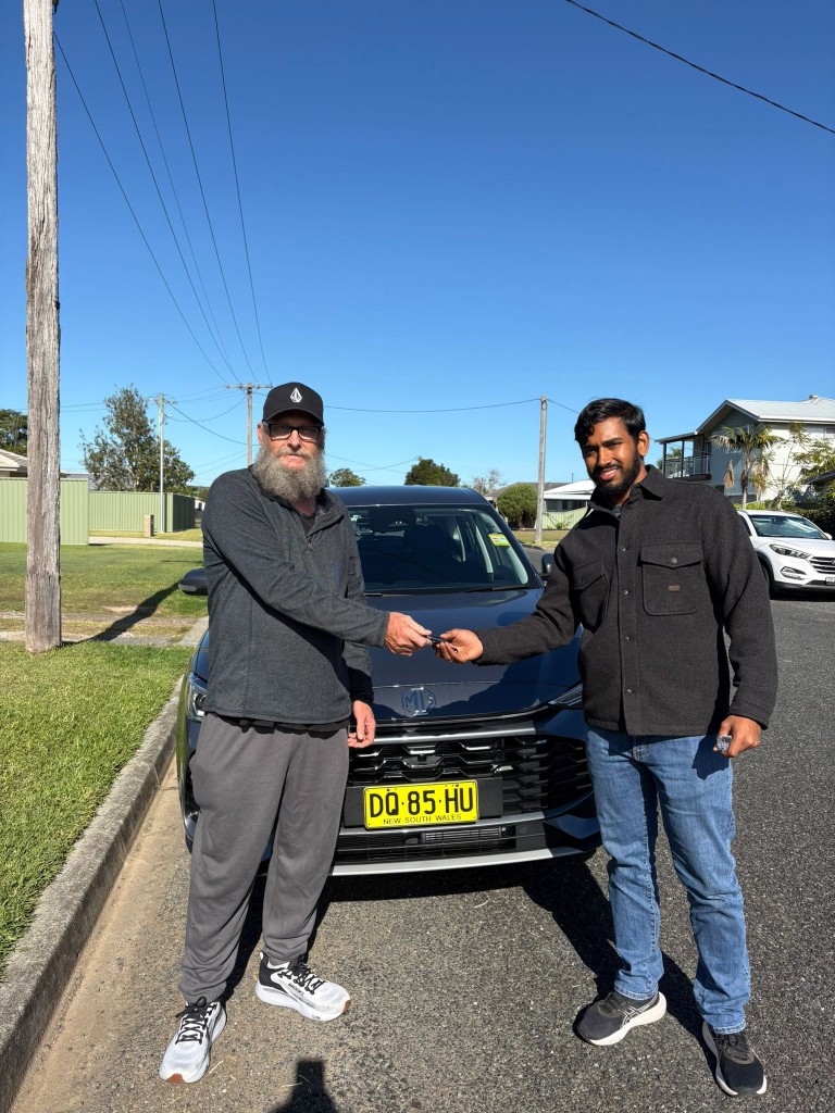 A customer collecting their car at a Car Rentals Near Me handover